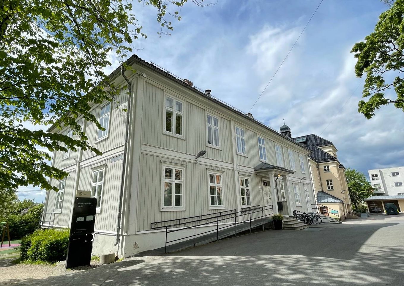 en hvit bygning med svart rekkverk